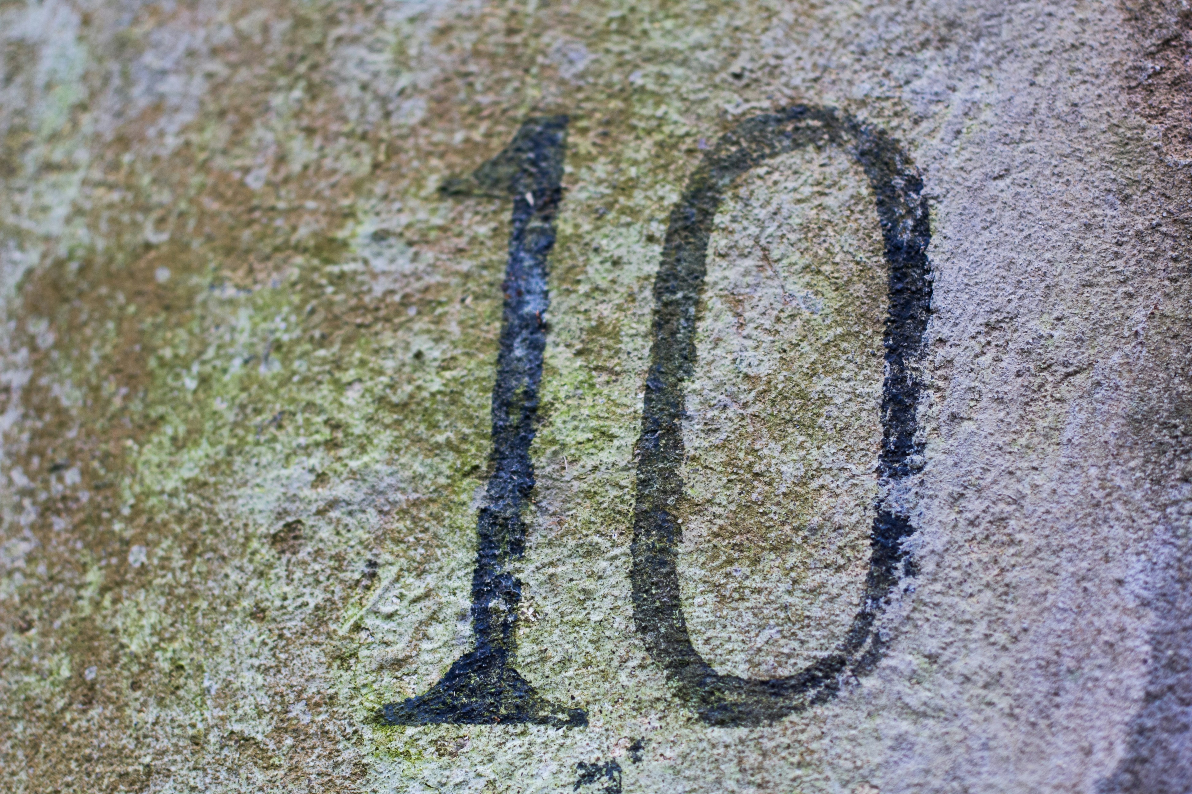 The number 10 carved into weathered stone